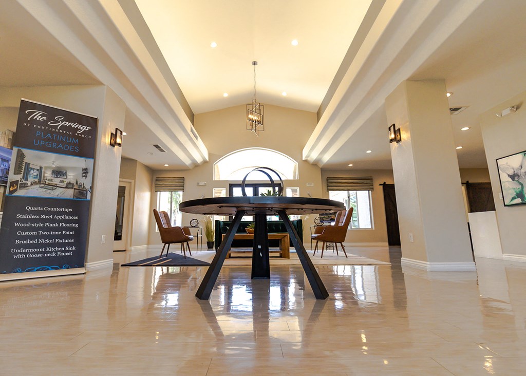 a large dining room with a table and chairs