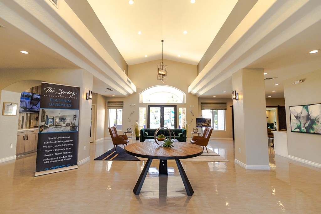 a large room with a table and chairs in the middle of it