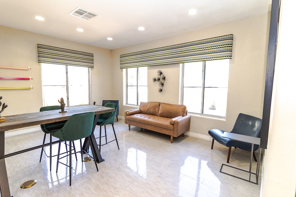 a living room with a couch and a table with chairs