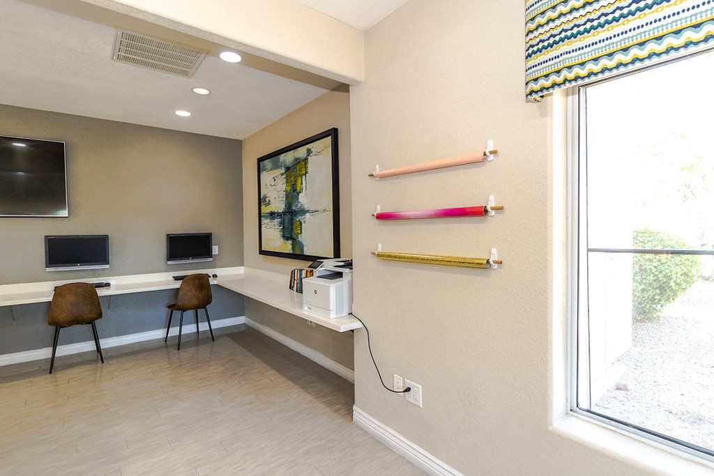 a room with two computers and two chairs