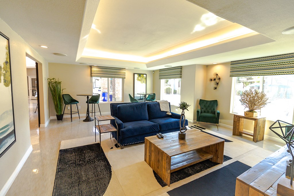 a living room with a blue couch and a wooden coffee table