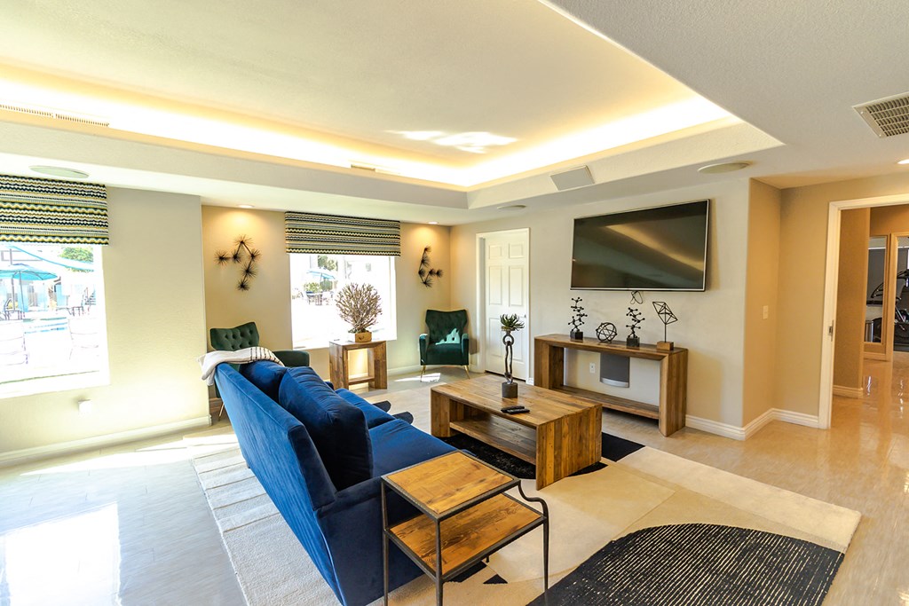 a living room with a blue couch and a wooden coffee table