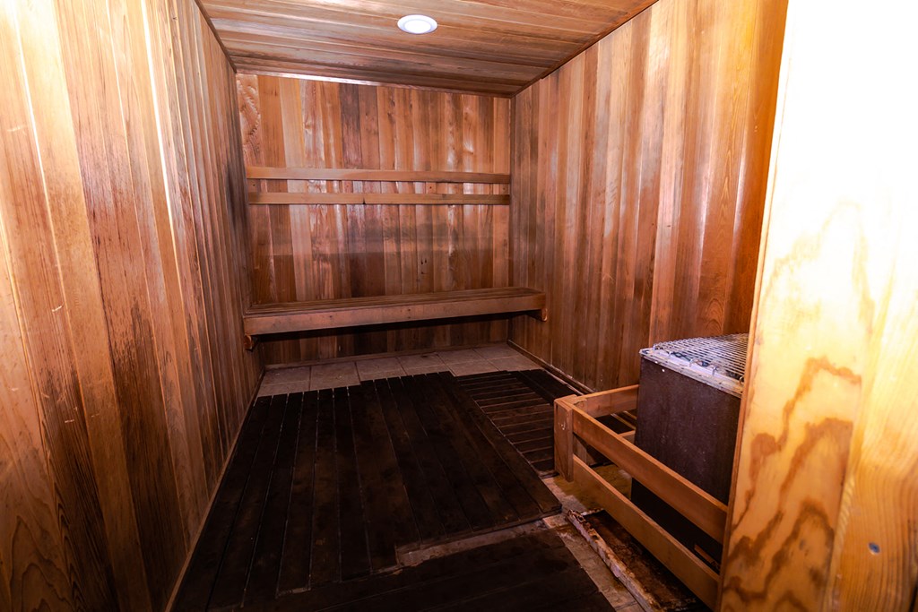 an empty sauna with wooden walls and floors