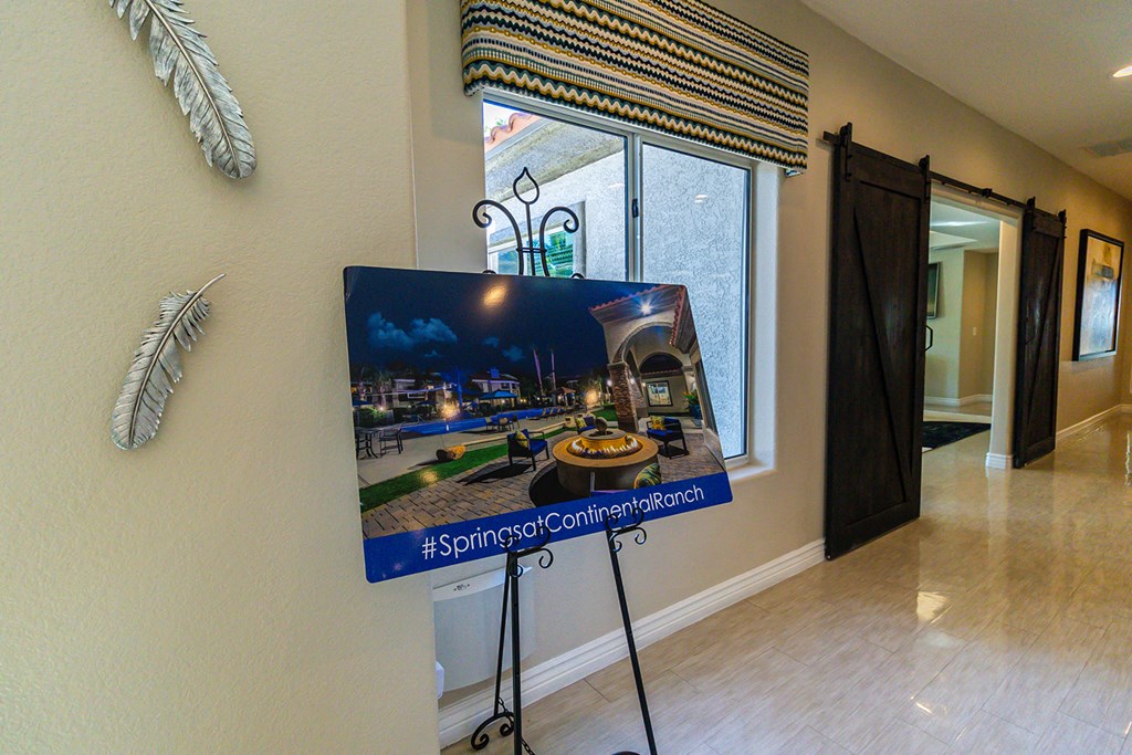 a large monitor in a lobby with a picture of a building on it