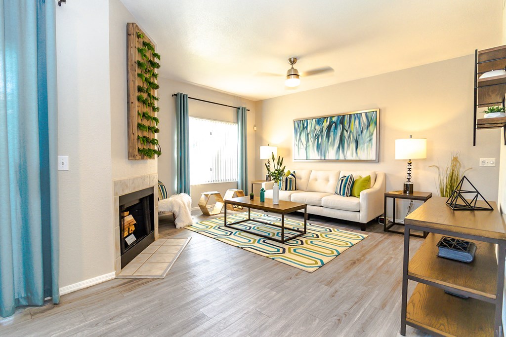 a living room with a fireplace and a large window