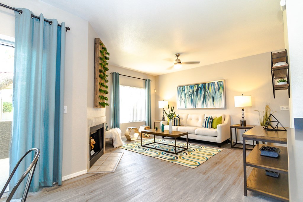 a living room with a white couch and a blue curtain
