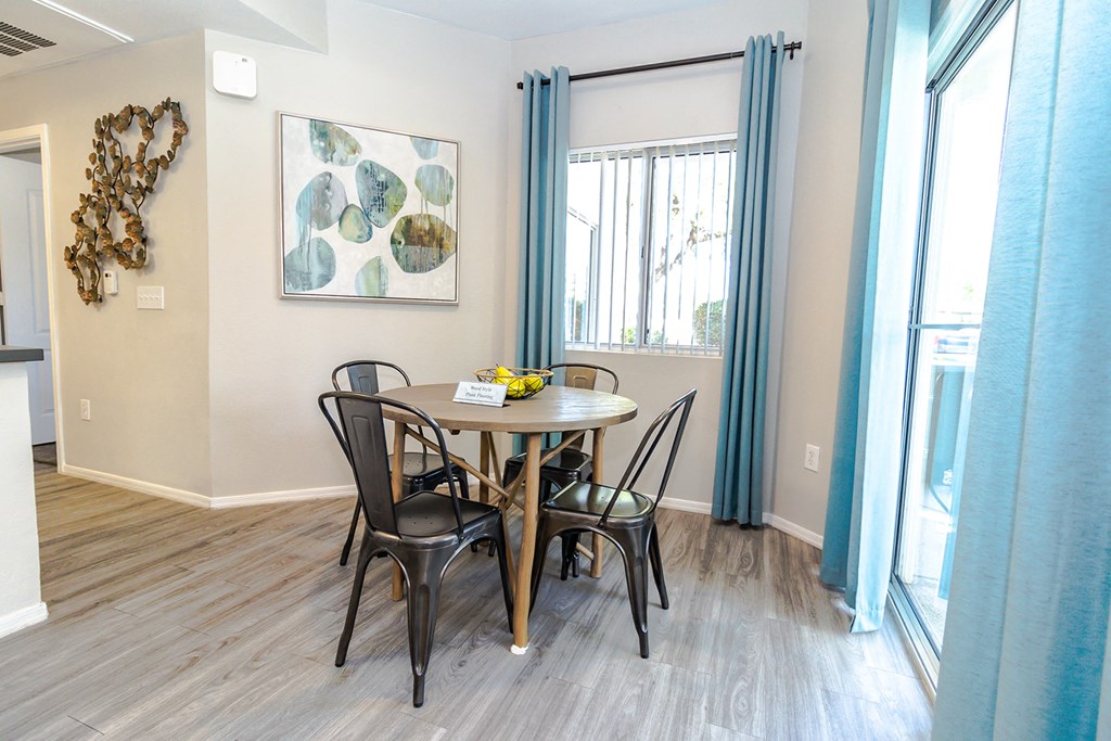a dining area with a table and four chairs