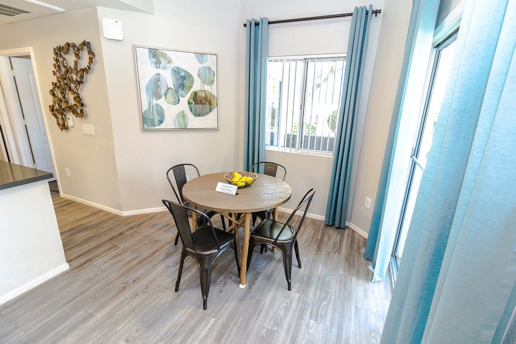 a dining area with a table and four chairs