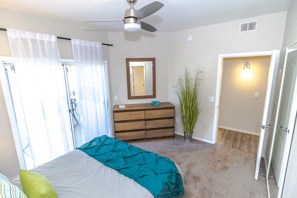 a bedroom with a bed and a ceiling fan