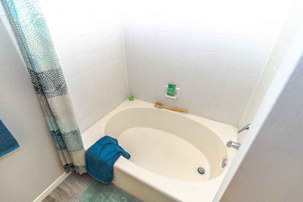 a bathroom with a bathtub and a shower curtain