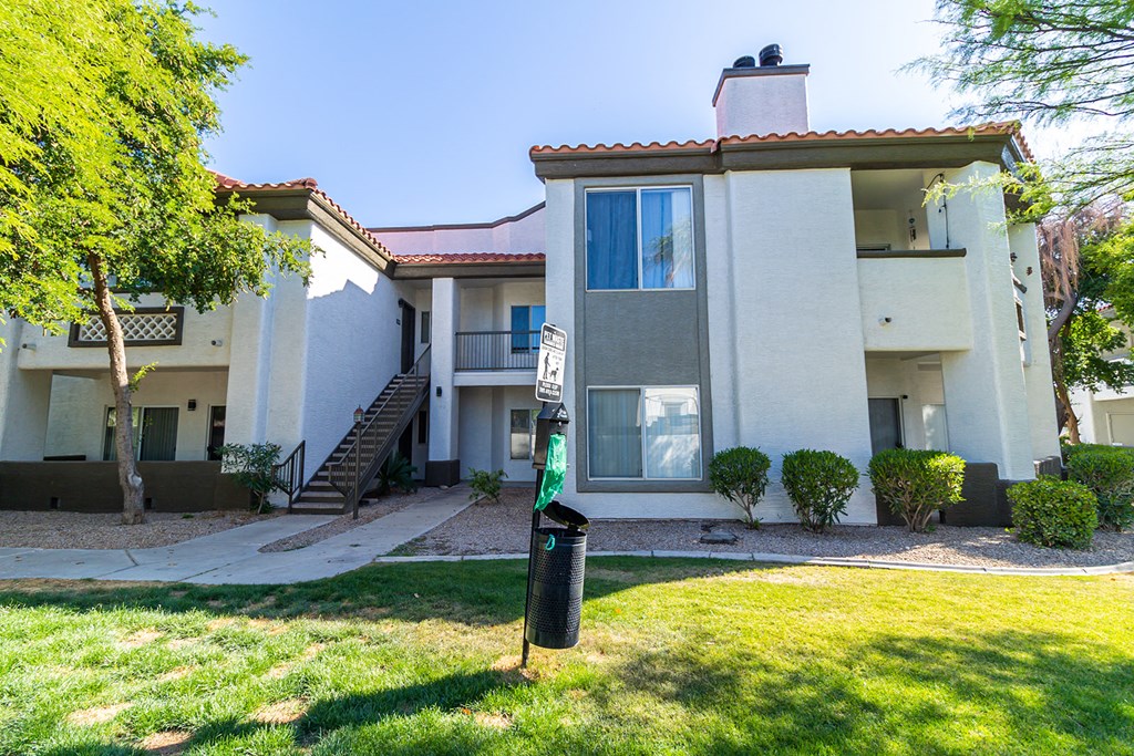 an apartment building with a yard in front of it