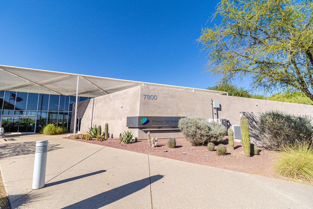 a stone building with a large awning and a bench in front of it