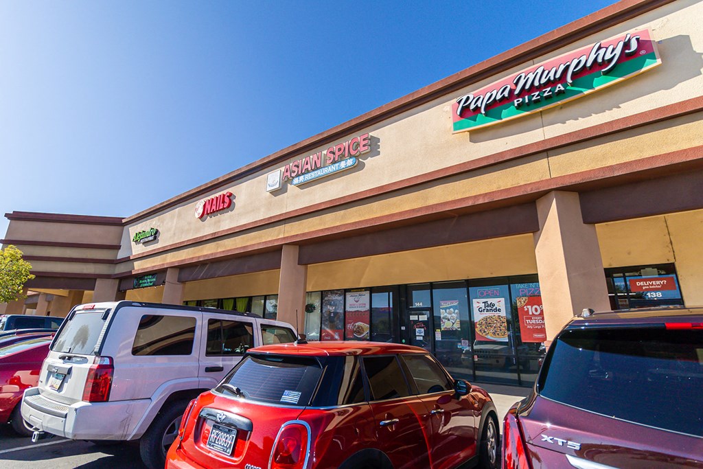 a car dealership with a red suv parked in front of it