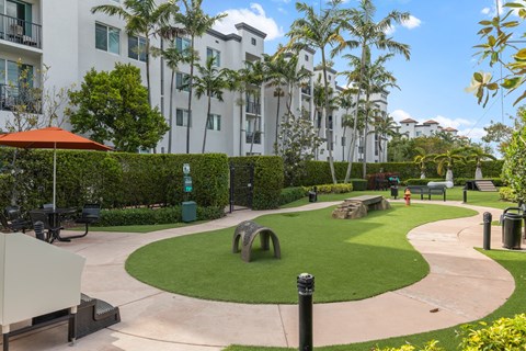 A park with a grassy area and a walking path.