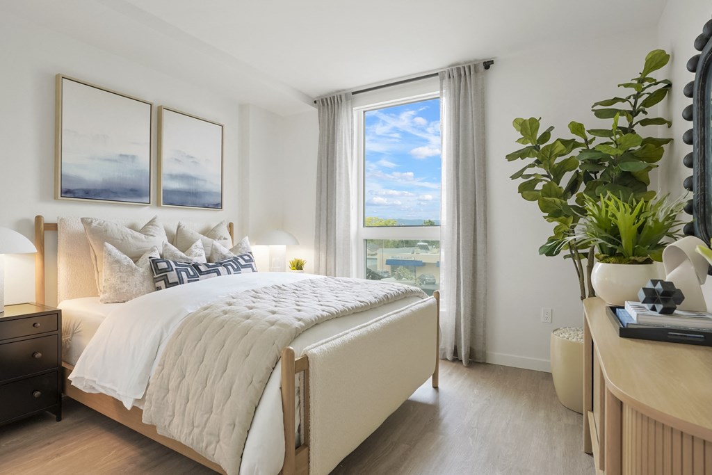 a bedroom with a large bed and a window