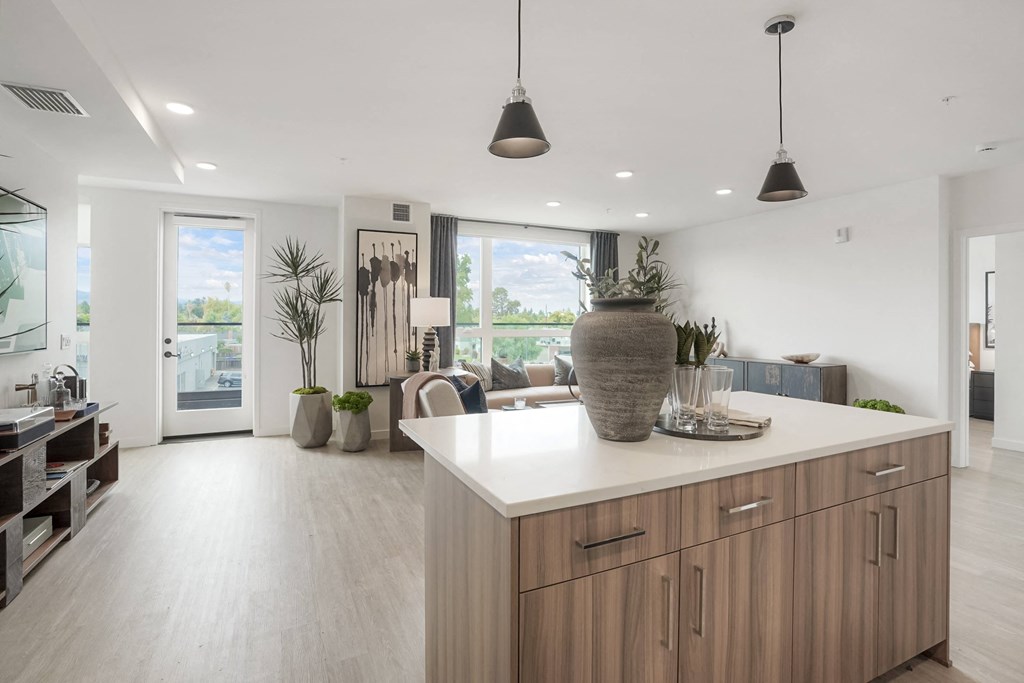 a kitchen with an island and a living room
