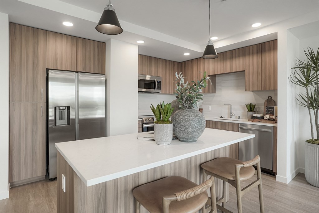 the preserve at ballantyne commons open concept kitchen with island and stainless steel refrigerator