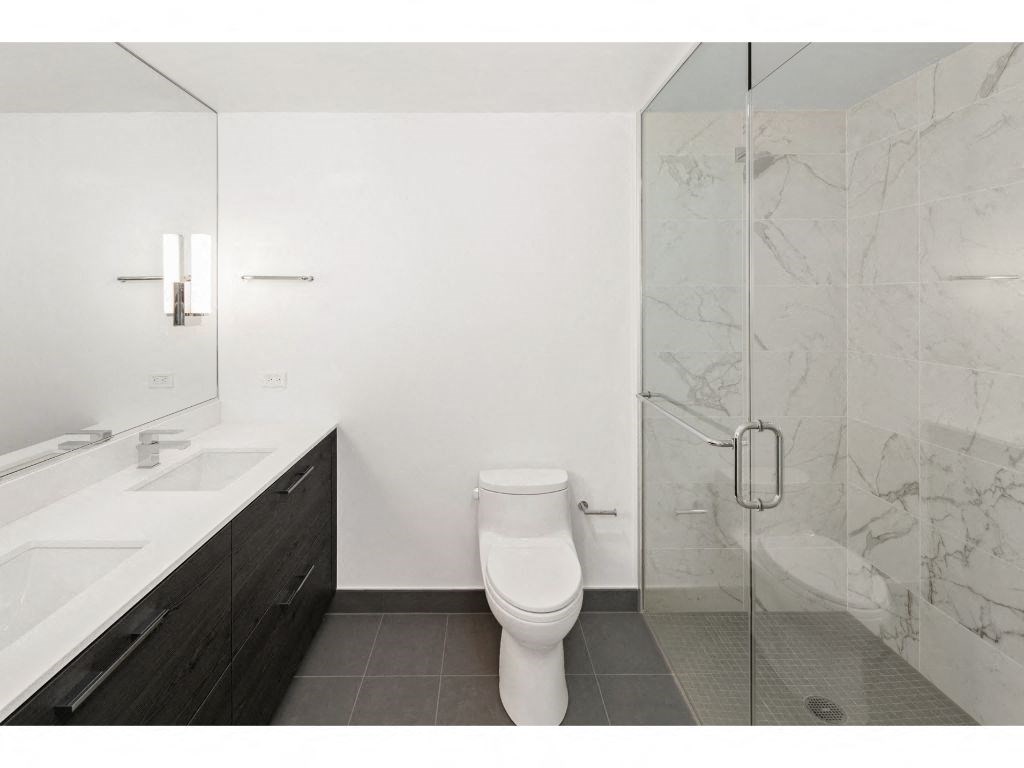 a bathroom with a toilet sink and shower