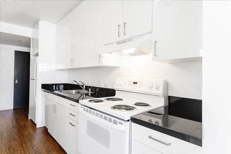 a kitchen with a stove top oven next to a sink