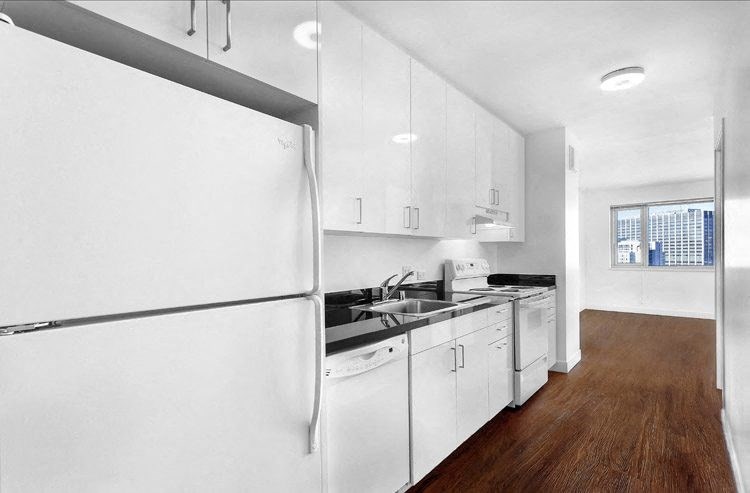 a kitchen with a white refrigerator freezer next to a stove top oven