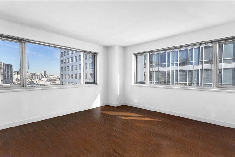 an empty room with three windows