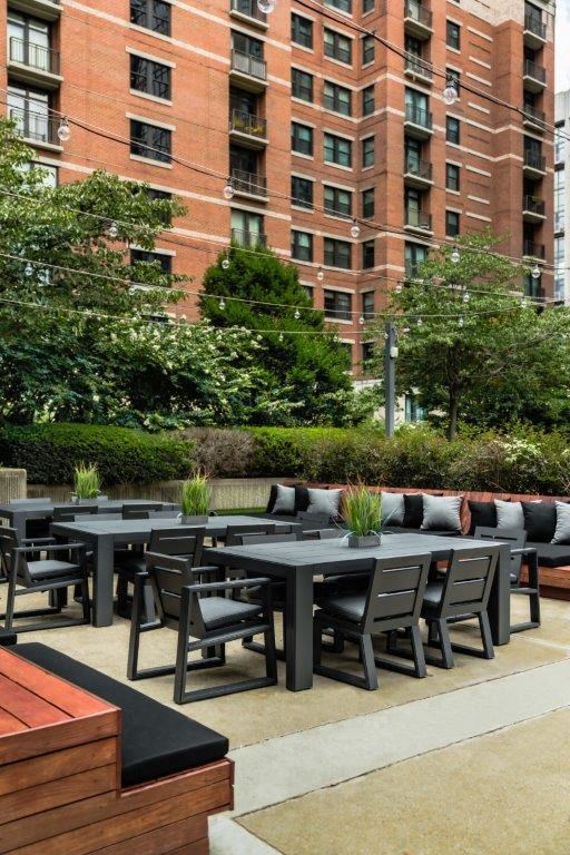 the patio of the building has tables and chairs