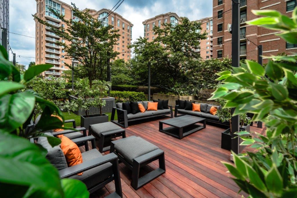 a large patio with couches and tables on a rooftop