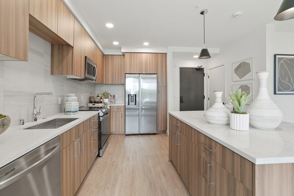 a large kitchen with wooden cabinets and stainless steel appliances