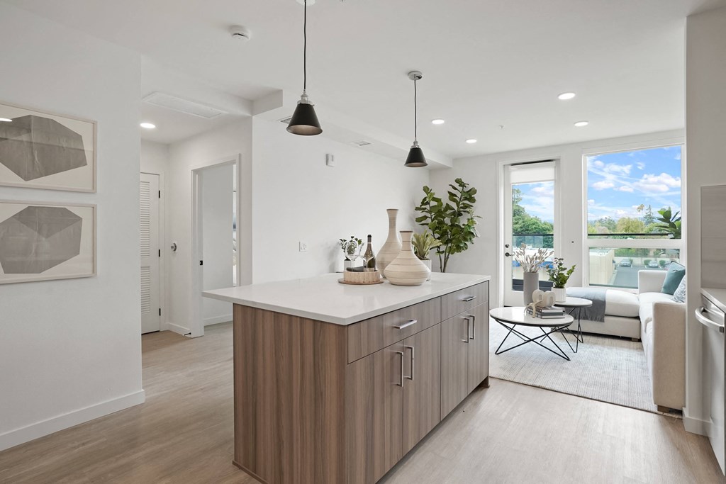 a kitchen with an island and a living room with a couch