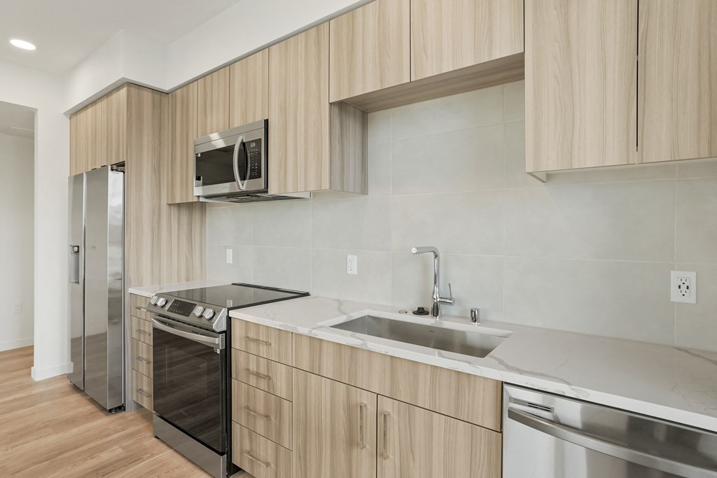 a kitchen with a sink and a stove and a microwave