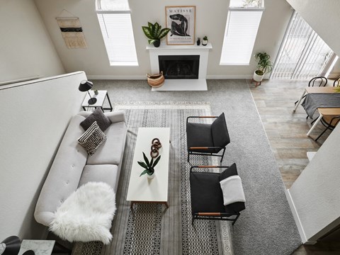 an aerial view of a living room with furniture and a fireplace