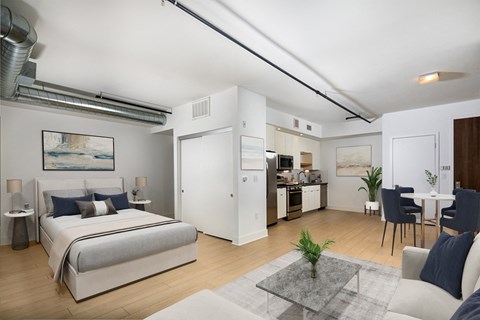 a bedroom with a bed and a living room with a kitchen  at The LC, Los Angeles