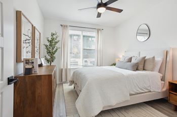 a bedroom with a bed and a ceiling fan