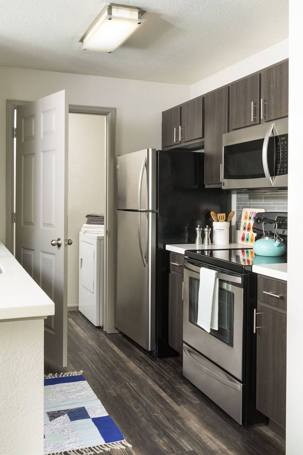 A kitchen with a black fridge and stove.