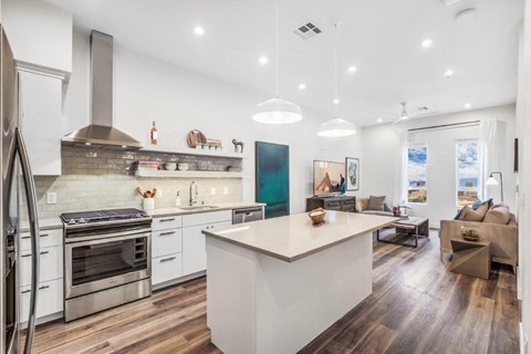 a kitchen and living room with a white counter top