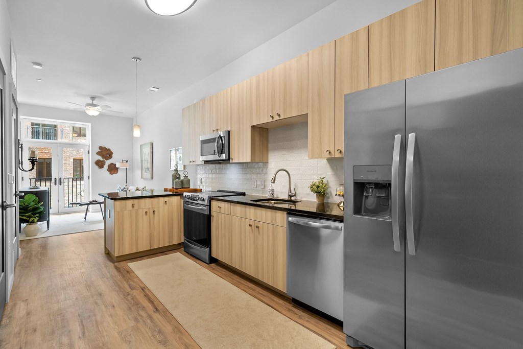a kitchen with wooden cabinets and stainless steel appliances