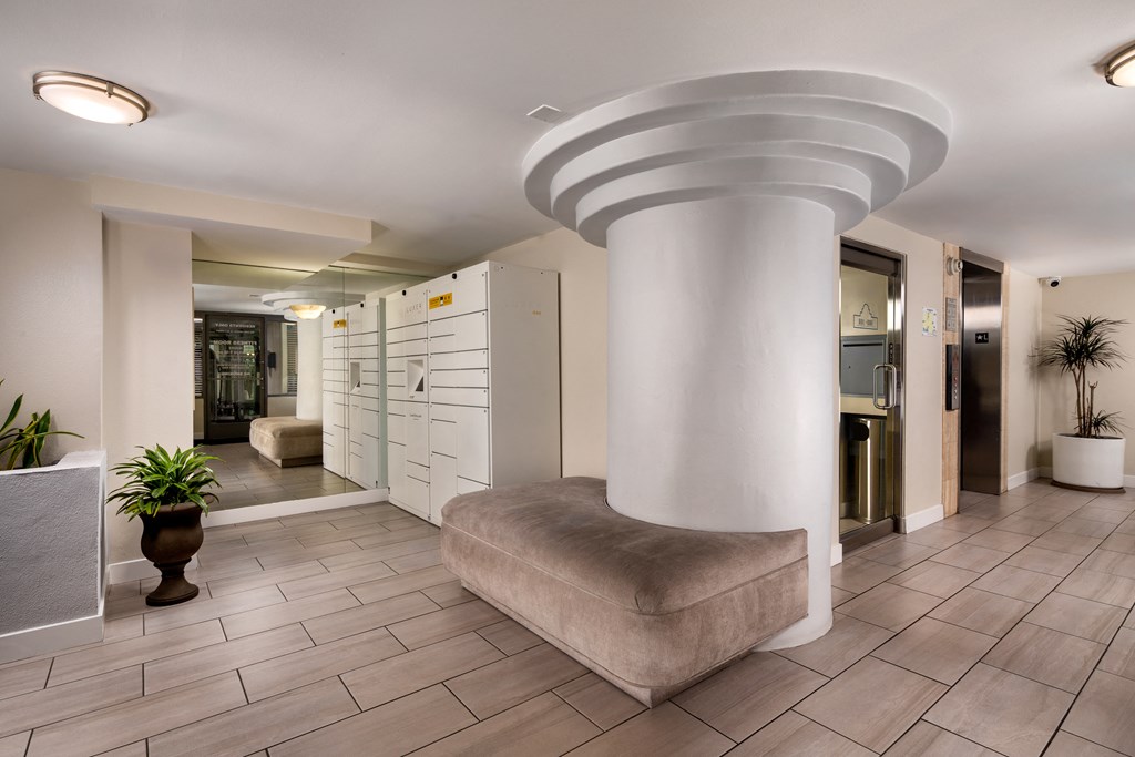 a lobby with a large pillar in the middle of it