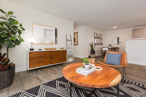 A living room with a wooden coffee table and a blue chair.