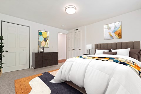 A bedroom with a large bed and a painting on the wall.