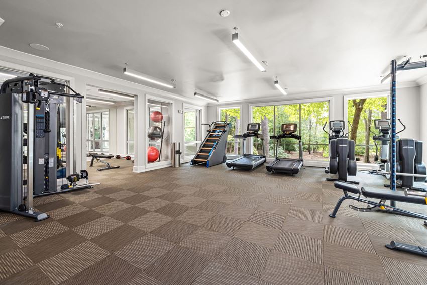 a workout room with a lot of exercise equipment - Photo Gallery
