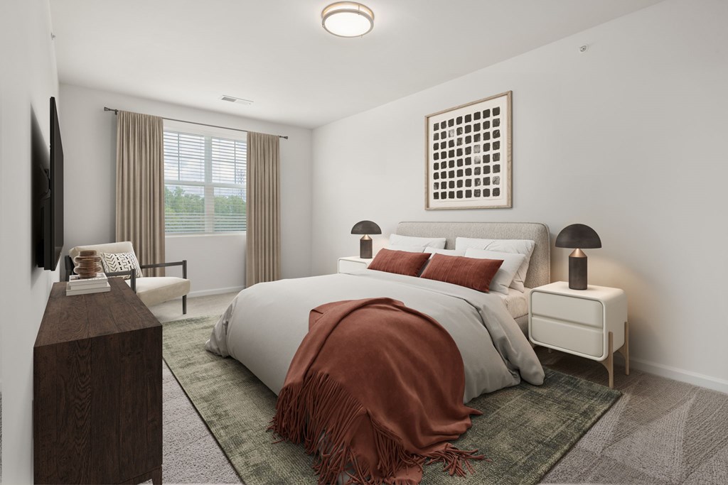 A bedroom with a large bed and a television on the wall.