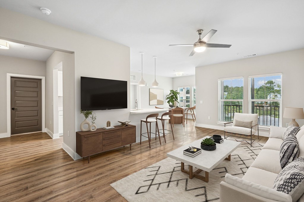 A2 A living room with a white couch, a wooden coffee table, and a flat-screen TV.