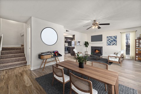 A living room with a fireplace and a ceiling fan.