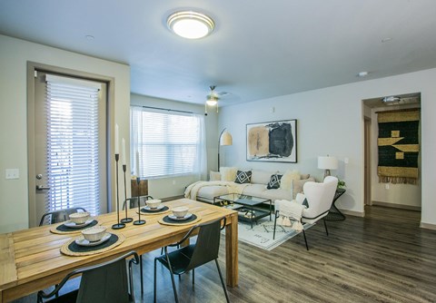A dining room with a wooden table and chairs.