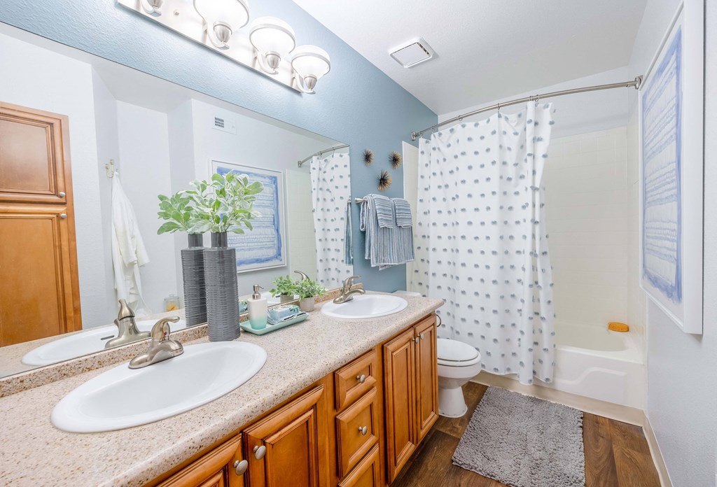 a bathroom with two sinks and a toilet