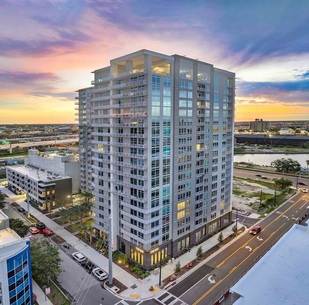 an aerial view of a tall apartment building on a city street