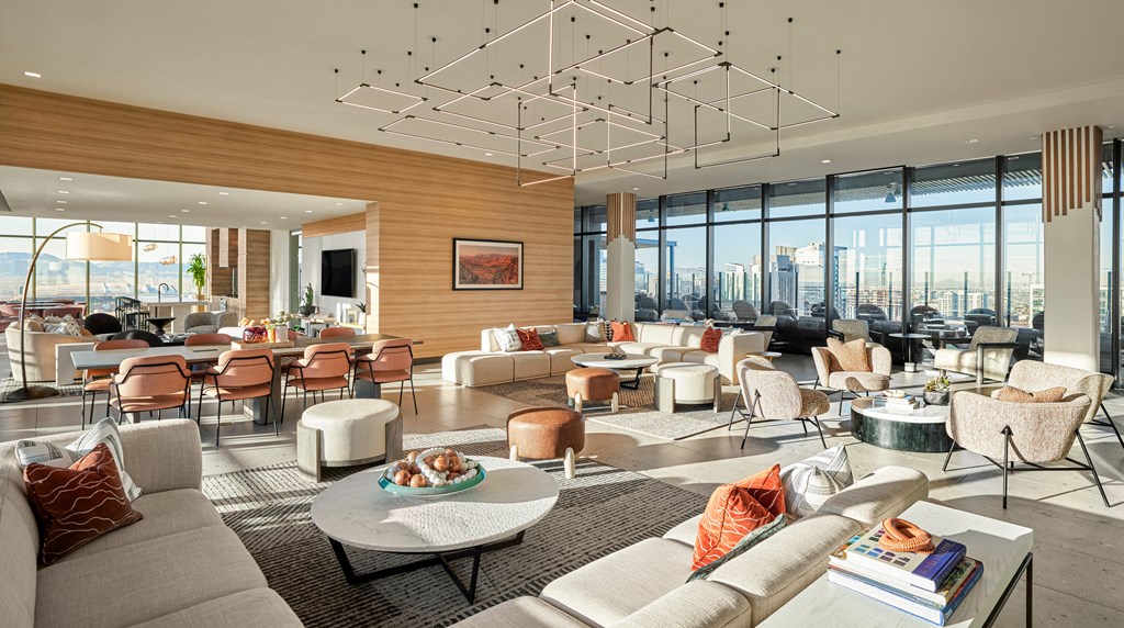 a living room filled with furniture and a large window view of a city