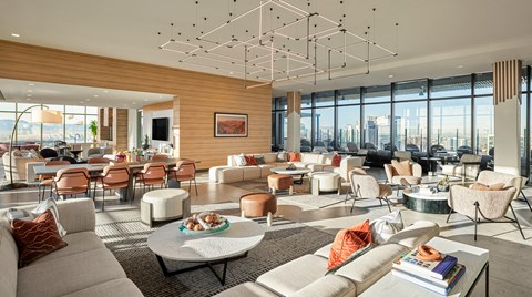 a living room filled with furniture and a large window view of a city