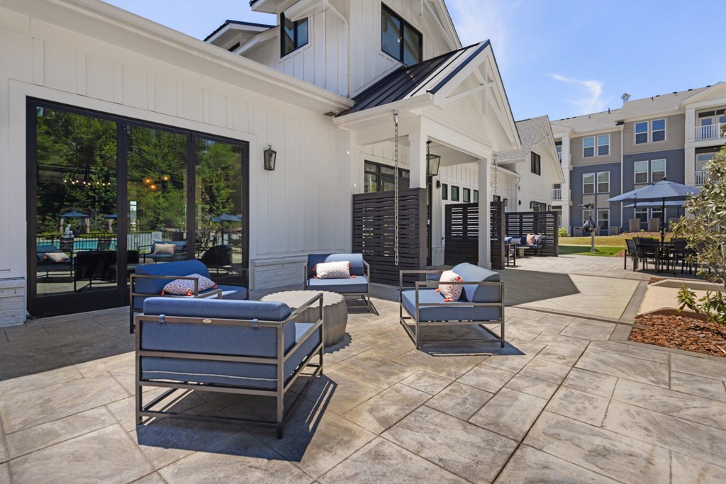 A patio with two lounge chairs and a table.
