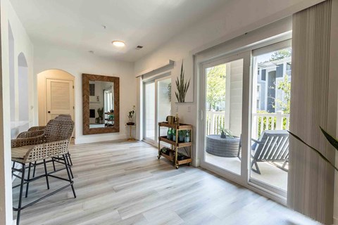A living room with a chair and a mirror.